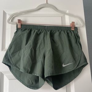 Olive green Nike running shorts.